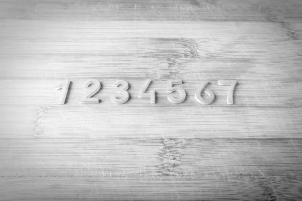 Number from one to seven on a wooden background — Stock Photo, Image