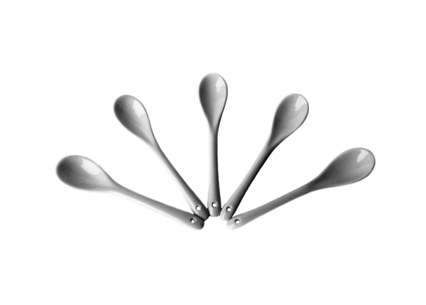 Ceramic spoons stacked square isolated on white background — Stock Photo, Image