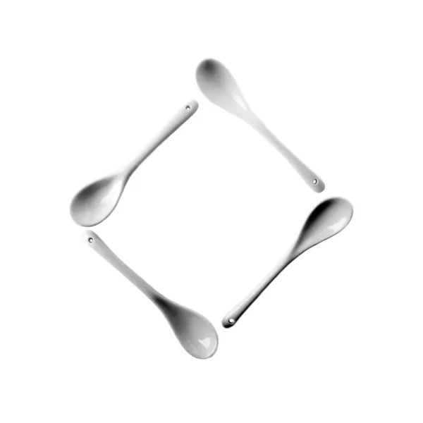 Four ceramic spoons stacked in the shape of a square isolated on white background — Stock Photo, Image