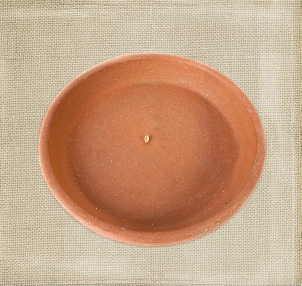 Empty clay plate isolated over bagging background in old style — Stock Photo, Image