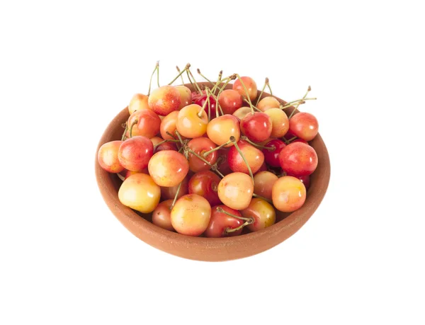 Red and yellow cherries in clay bowl isolated on white background — Stock Photo, Image