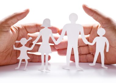 Cardboard figures of the family on a white background. clipart