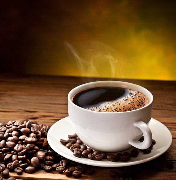 Coffee cup and saucer on a wooden table.