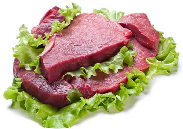 Raw meat on lettuce leaves. — Stock Photo, Image