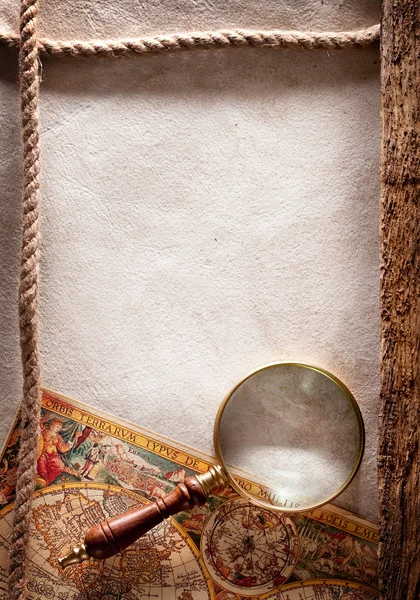 Magnifying glass on old parchment. — Stock Photo, Image