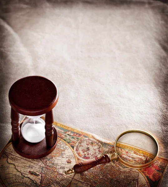 Hourglass with a magnifying glass. — Stock Photo, Image