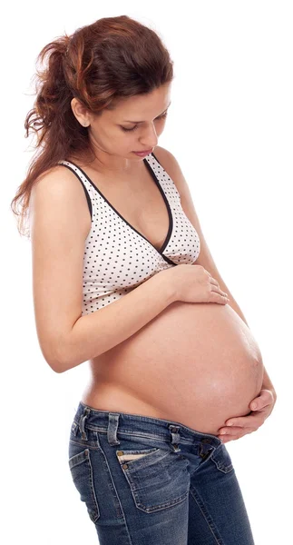 Mulher grávida feliz mantendo as mãos em sua barriga . — Fotografia de Stock