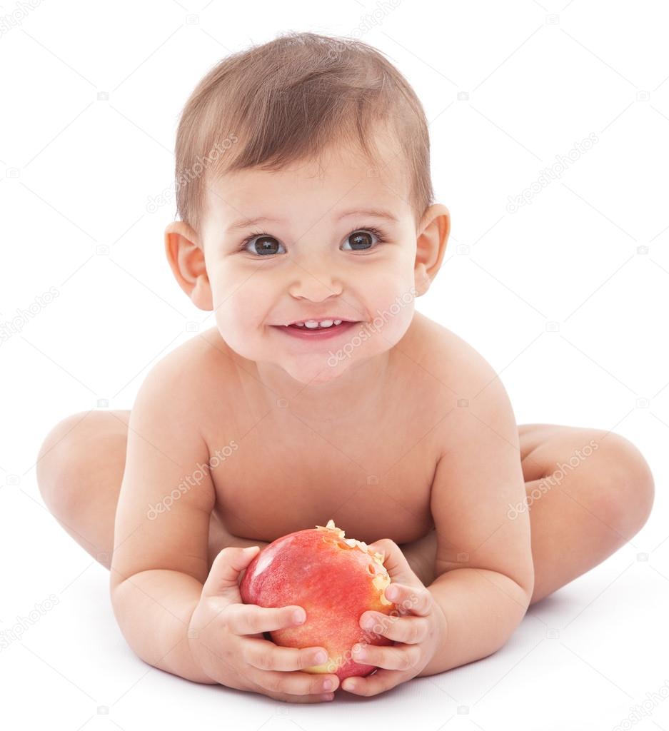 Happy baby with a big apple in her hands.