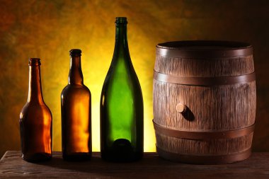 Wooden barrel with colors bottles. clipart