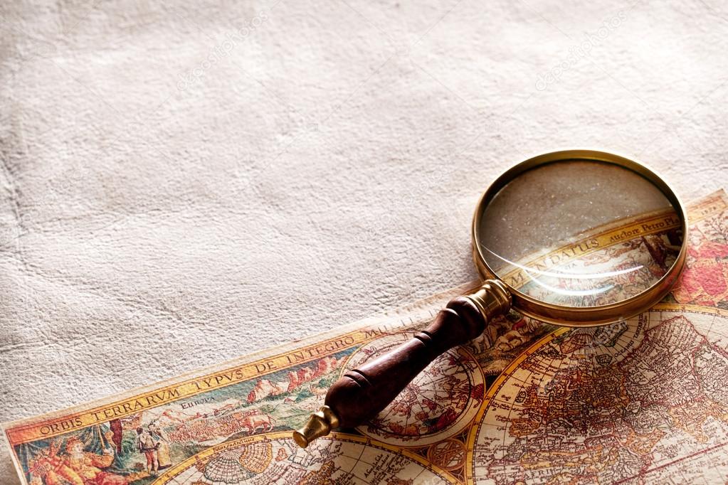 Magnifying glass on old parchment.