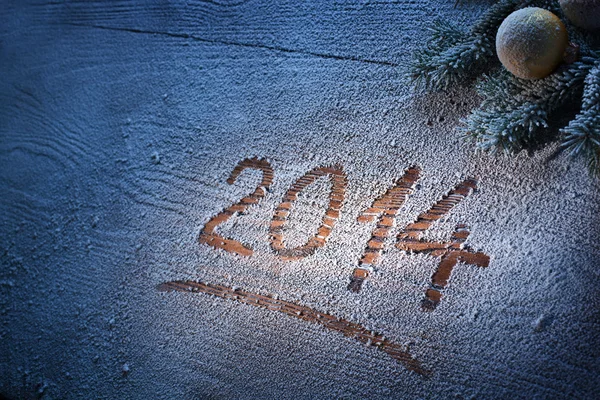 New Year 2014 on snow-covered wooden desk. — Stock Photo, Image