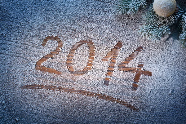 New Year 2014 on snow-covered wooden desk. — Stock Photo, Image