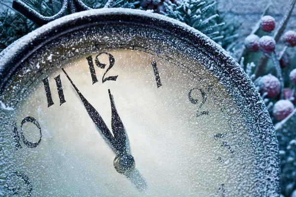 New Year clock powdered with snow. Stock Photo