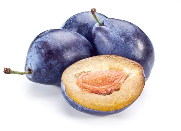 Plums with a half of one. — Stock Photo, Image