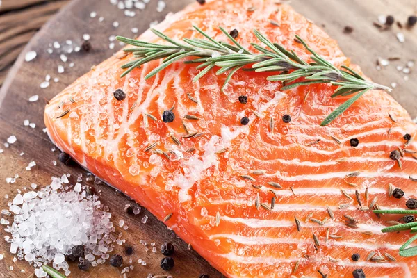 Filete de salmón en una tabla de talla de madera. — Foto de Stock