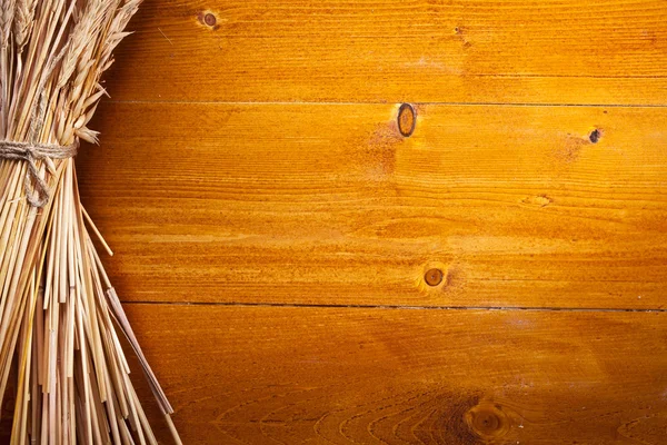 Ears of wheat on old wooden table. — Stock Photo, Image