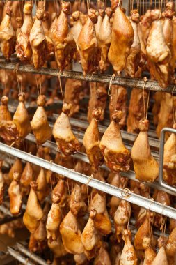 Production of smoked chicken legs.  clipart