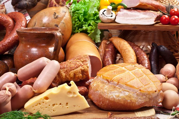 Variety of sausage products, cheese, eggs and vegetables. — Stock Photo, Image