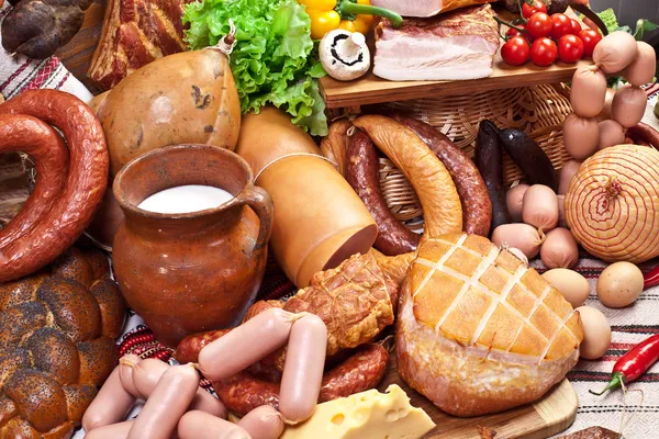 Variety of sausage products, cheese, eggs and vegetables. — Stock Photo, Image