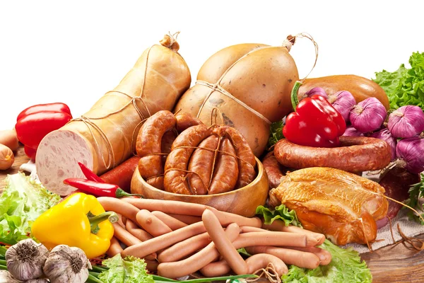 Variety of sausage products with vegetables. Clipping path. Royalty Free Stock Images