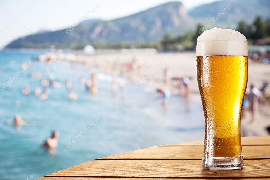 Beer glass on the bar table at the openair cafe. Stock Photo by