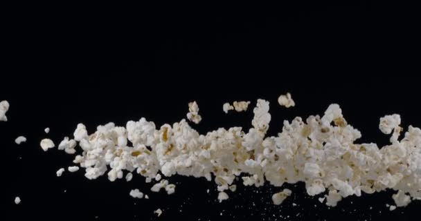 Serpih Popcorn Perlahan Naik Dan Jatuh Melawan Latar Belakang Hitam — Stok Video