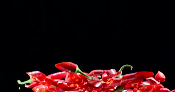 Red Chili Peppers Slowly Fly Fall Black Background Blackmagic Ursa — Stock Video