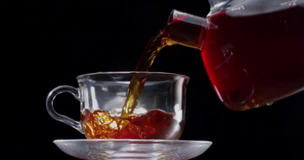 Tea Slowly Poured Glass Cup Teapot Black Background — Stock Video