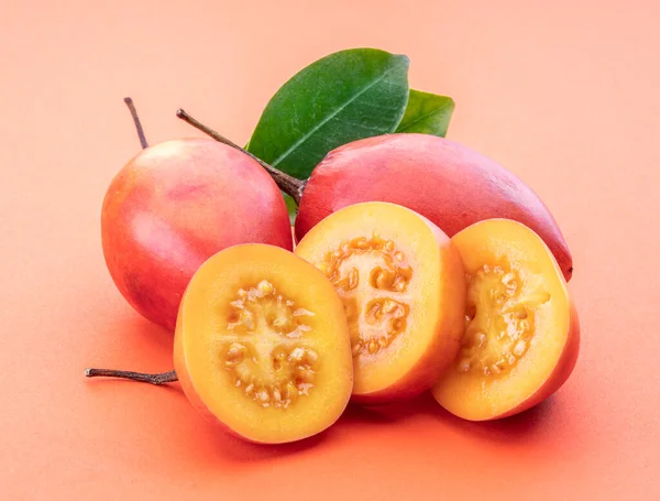 Ripe Tamarillo Fruits Slices Tamarillo Leaves Isolated Orange Background — Stock Photo, Image