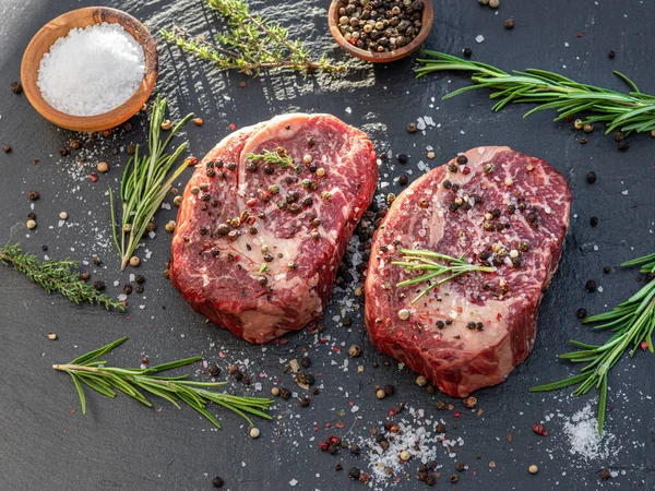 Raw Ribeye Steaks Salt Herbs Grey Board Top View — Stock Photo, Image