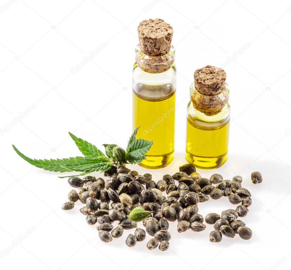 Cannabis seeds and hemp oil isolated on white background. Close up.