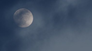 Full Orange Moon movement across the cloudy sky. Halloween Moon concept.  