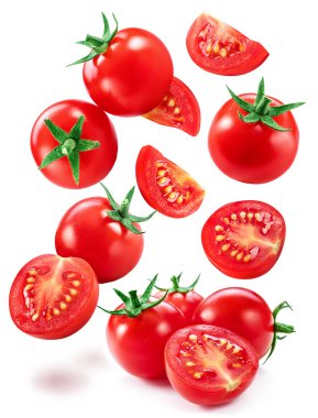 Falling cherry tomatoes and tomato slices isolated on white background. Macro shot. Popular worldwide product as ingredient in many mediterranean dishes.