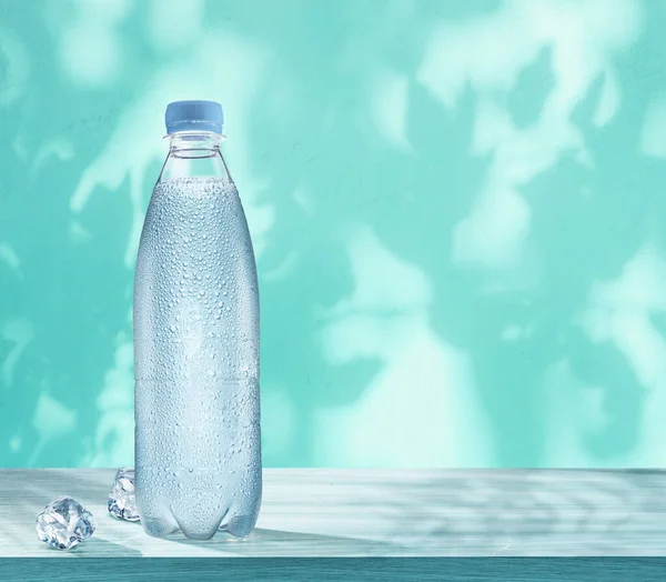 Plastic Bottle Chilled Water Condensation Drops Two Ice Cubes Table — Foto de Stock