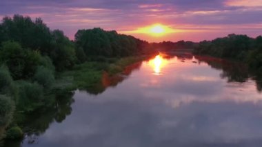 Beautiful aerial view video from a drone of Ukrainian nature - Seim river, morning sun in the mist on the river with trees and open spaces.