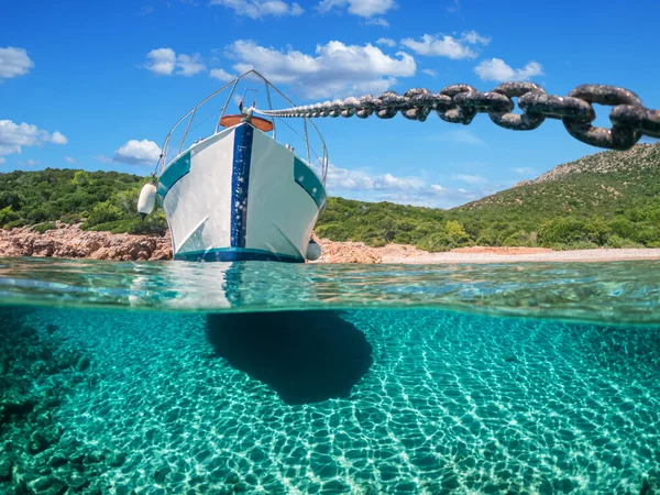 Split view - half underwater view of beautiful seabed with sea fishes and beautiful marine yacht, Turkey, Bodrum.