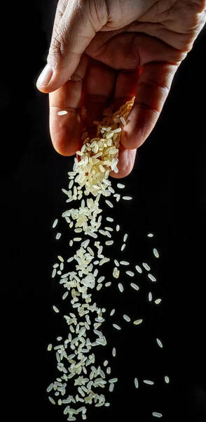 White Rice Grains Falling Spoon Black Background Popular Food Main — Stock Photo, Image