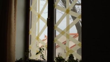 Ukrayna 'daki savaş sırasında parçaların patlamasını önlemek için pencerelere bantlanmış.