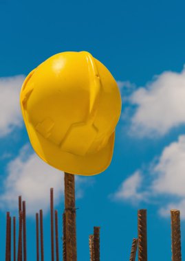 Construction helmet on steel bars clipart