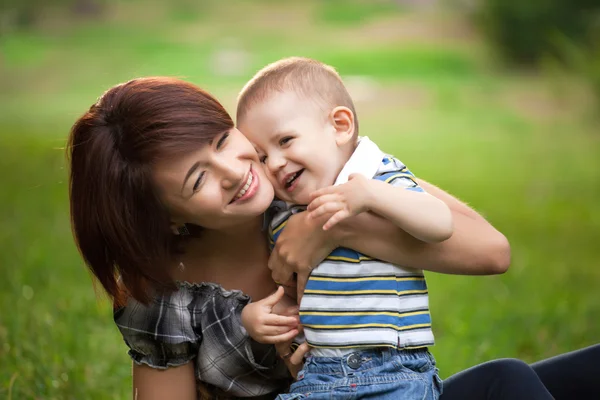 Happy little boy in the park with mother — Stock Photo, Image