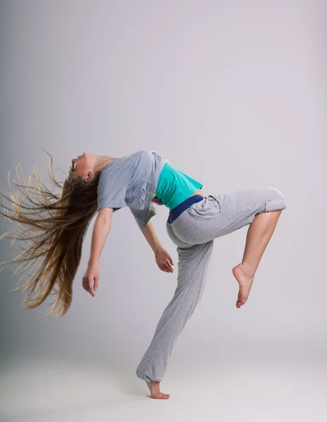 Modern ballet dancer dancing on the white studio background — Stock Photo, Image