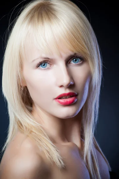 Portrait of a beautiful blonde girl on black background — Stock Photo, Image