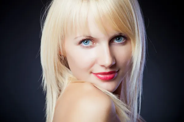 Portrait of a beautiful blonde girl on black background — Stock Photo, Image