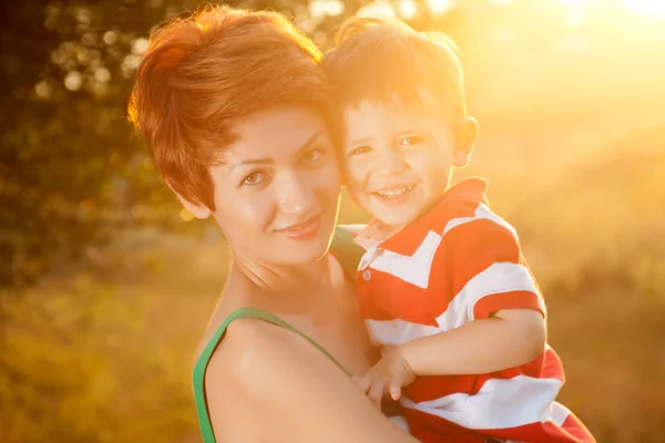 Happy little boy in the park with mother — Stock Photo, Image