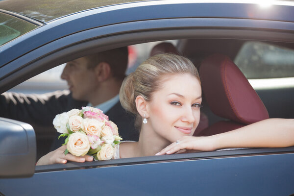 groom and bride, in car