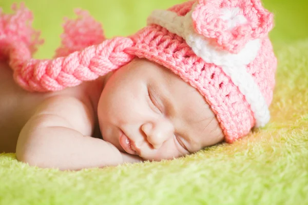 Bellissimo bambino addormentato con un cappello a strisce — Foto Stock