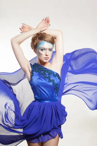 Sexy woman in fluttering blue dress — Stock Photo, Image