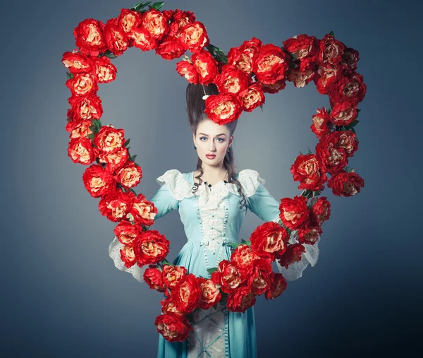 Old fashioned sexy woman with heart of flowers — Stock Photo, Image