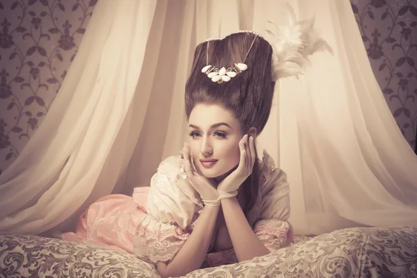 Old fashioned sexy woman in lingerie lying on bed — Stock Photo, Image