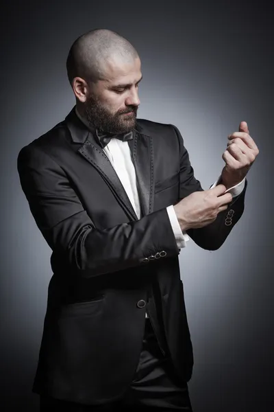 Stylish and brutal bald man with a beard  in elegant black suit — Stock Photo, Image